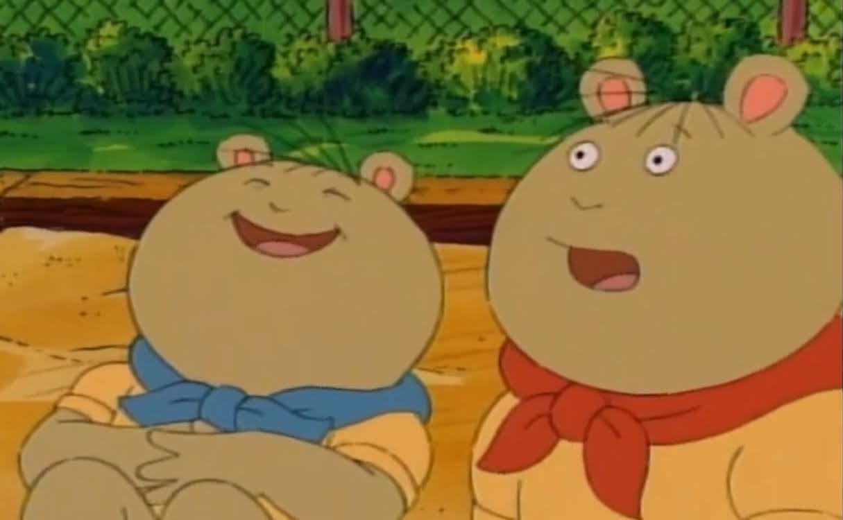 A screenshot of
              The twins from PBS's Arthur where the one wearing blue scraf is
              laughing and the one in the red scarf is shooked